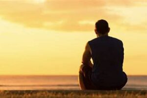 Man observing horizon back to the camera