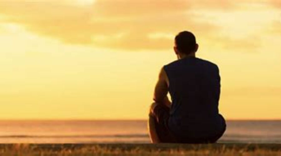 Man observing horizon back to the camera